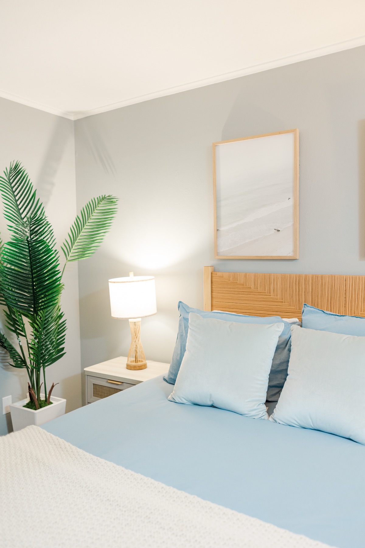 Coastal-blue bedroom with rattan headboard