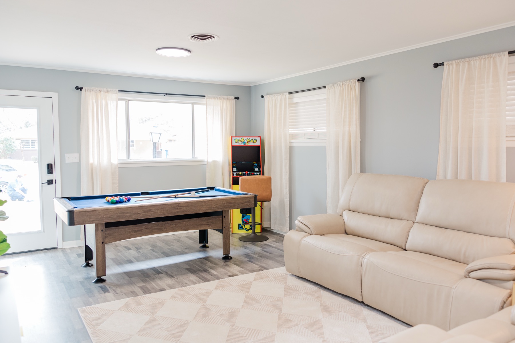 Game room with pool table and arcade